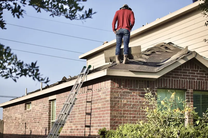 Professional roofer working on a residential roof in Orange Tree